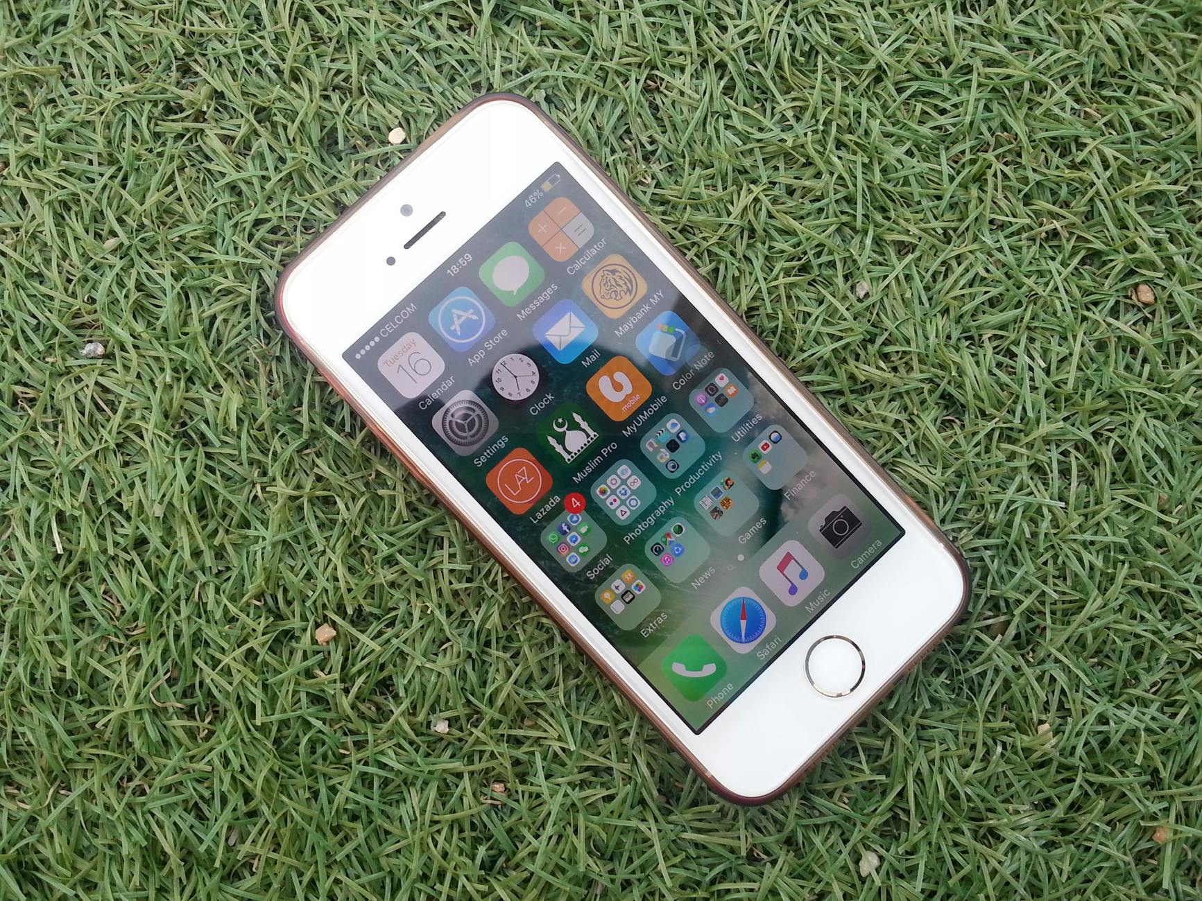 silver iphone on a green grass